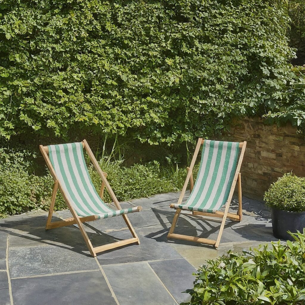 slate patio with empty deck chairs 