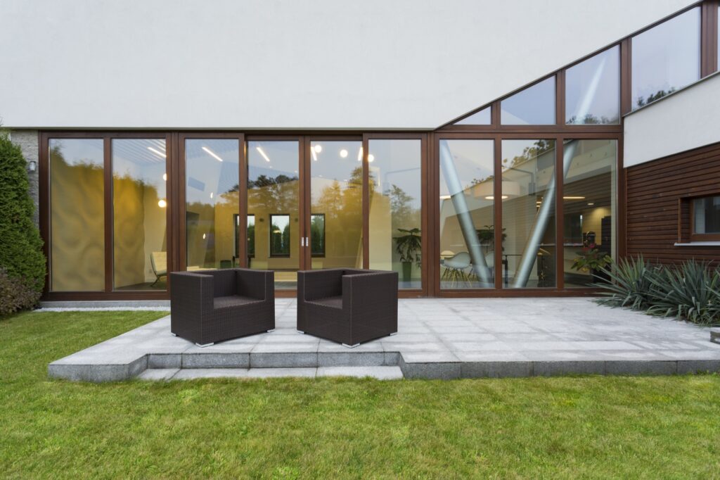 A modern concrete patio with a smooth gray finish and outdoor furniture